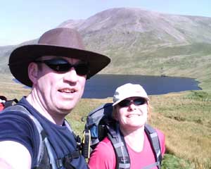 Steve and Steff with a lake and big hill in the background